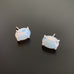 Opalescent moonstone color glass oval, sterling silver prong set post earrings.