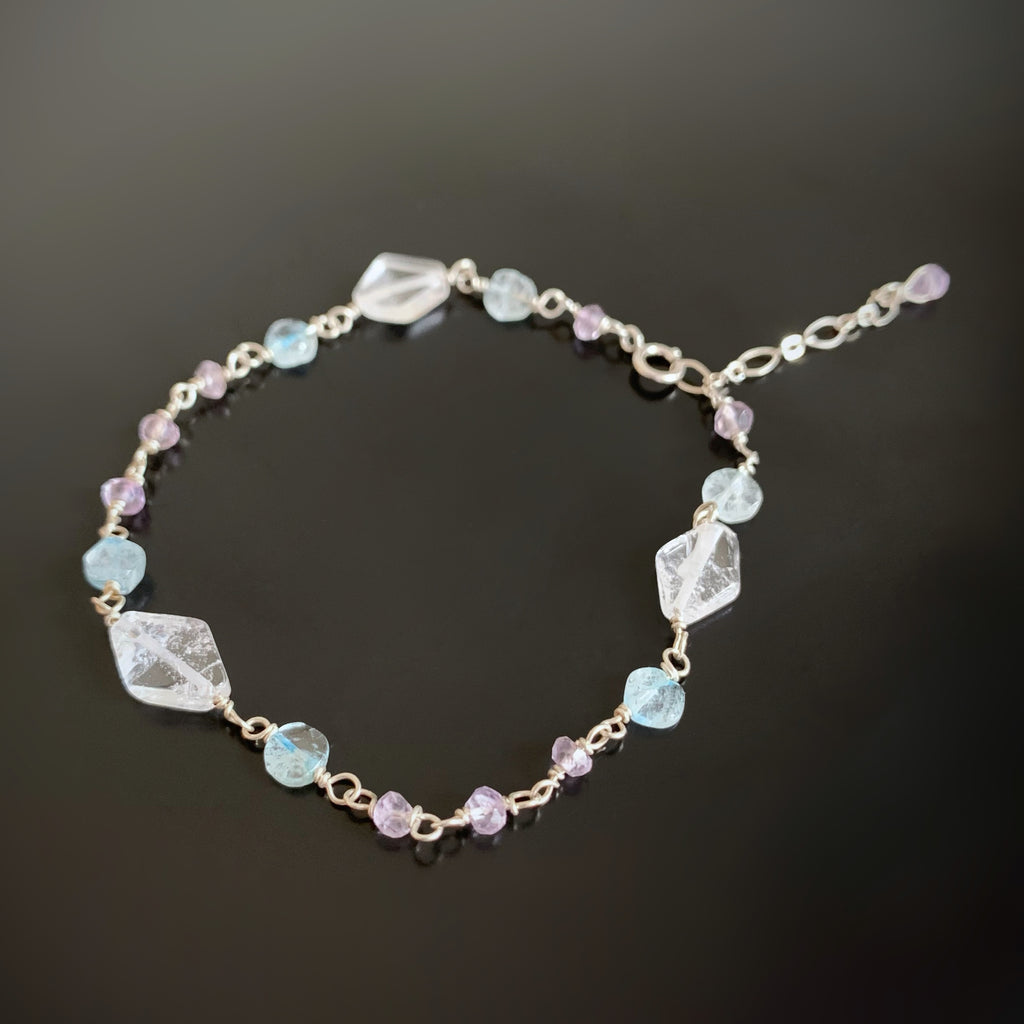 hand wrapped sterling silver bracelet with clear quartz, amethyst, and aquamarine