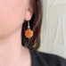 red aventurine carved flower dangle earrings with silvery accents