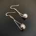 Sterling silver ball drop earrings on chain.