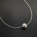 Sterling silver round ball slides on the thin rolo chain.