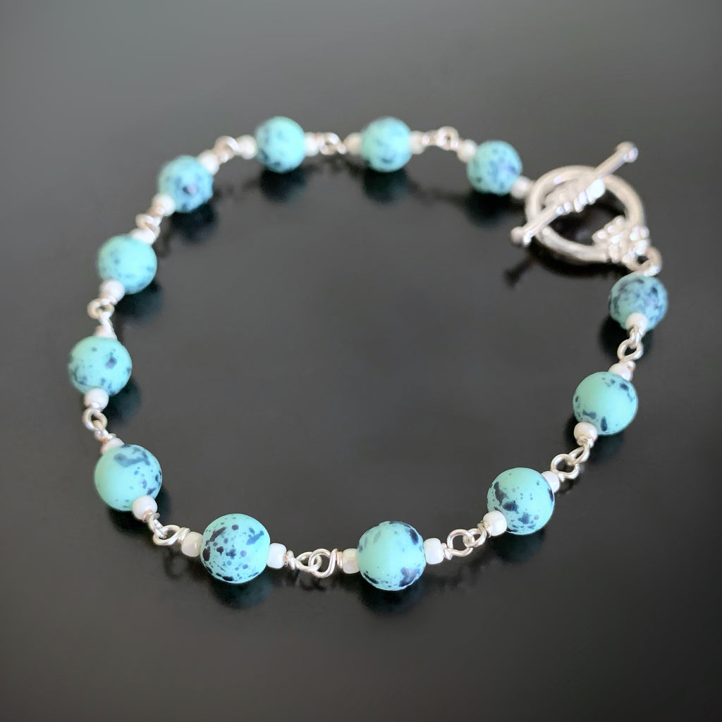 turquoise speckled glass beads linked together to create the bracelet